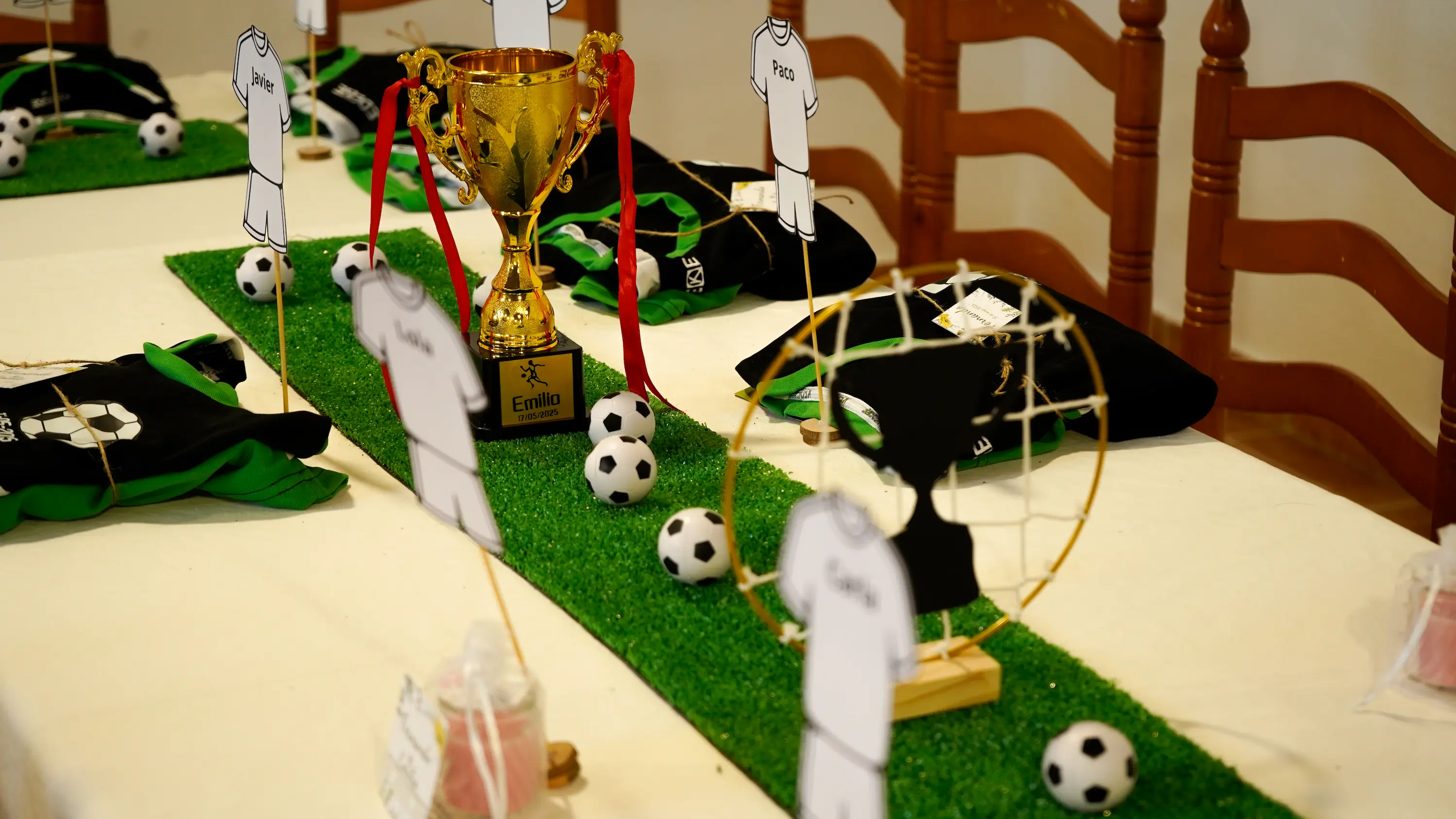 Mesa dulce temática de fútbol con trofeos y balones para fiesta infantil de comunión
